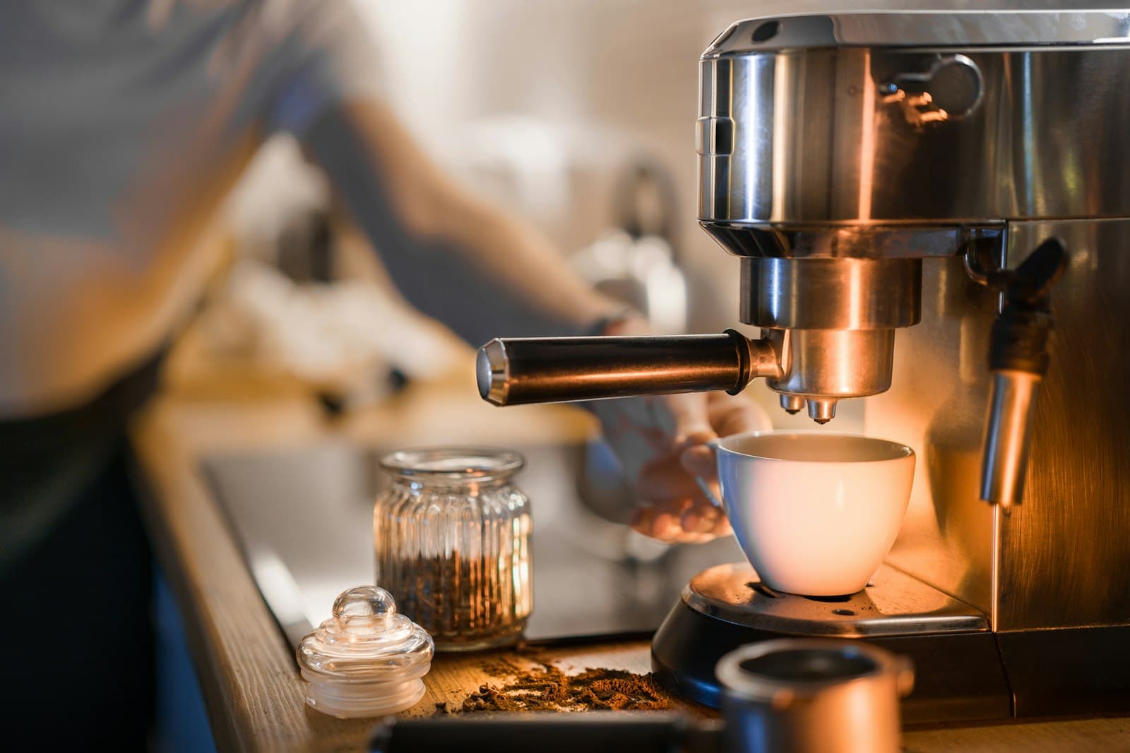 A coffee machine brewing a cup in a small apartment kitchen