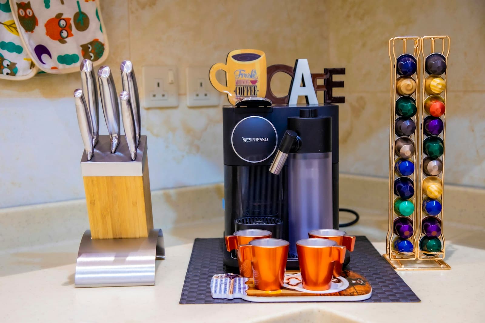 A compact pod coffee maker suited to a dorm desk