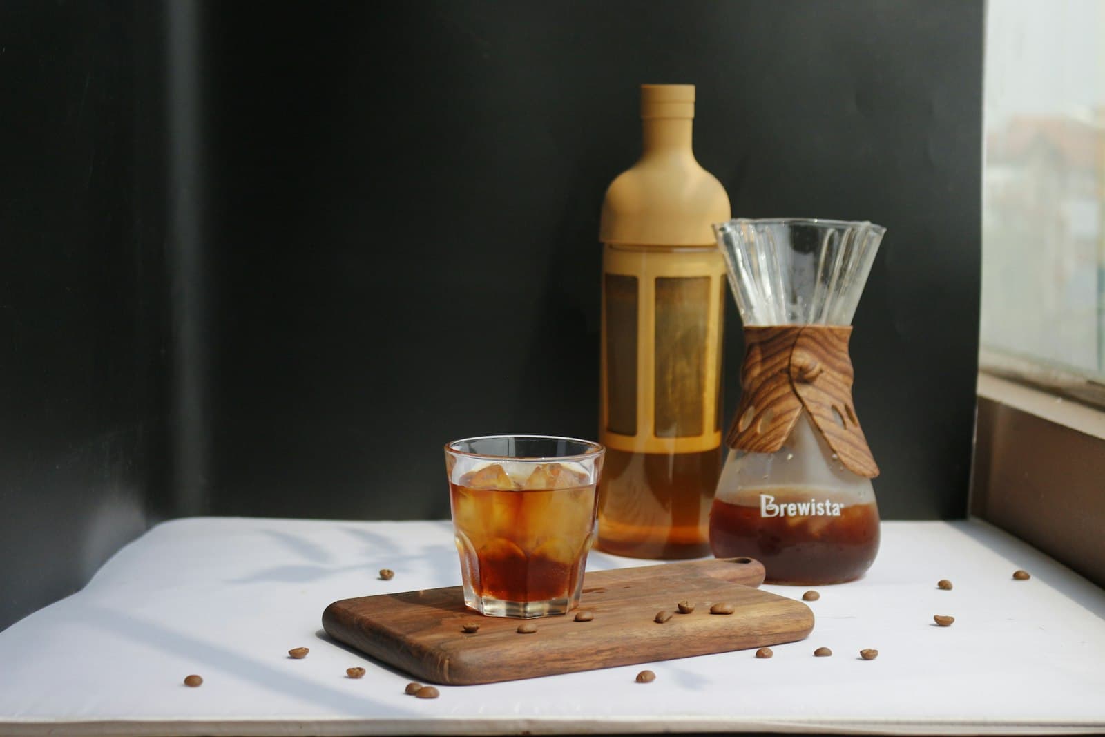 A glass of cold brew beside a bottle of concentrate