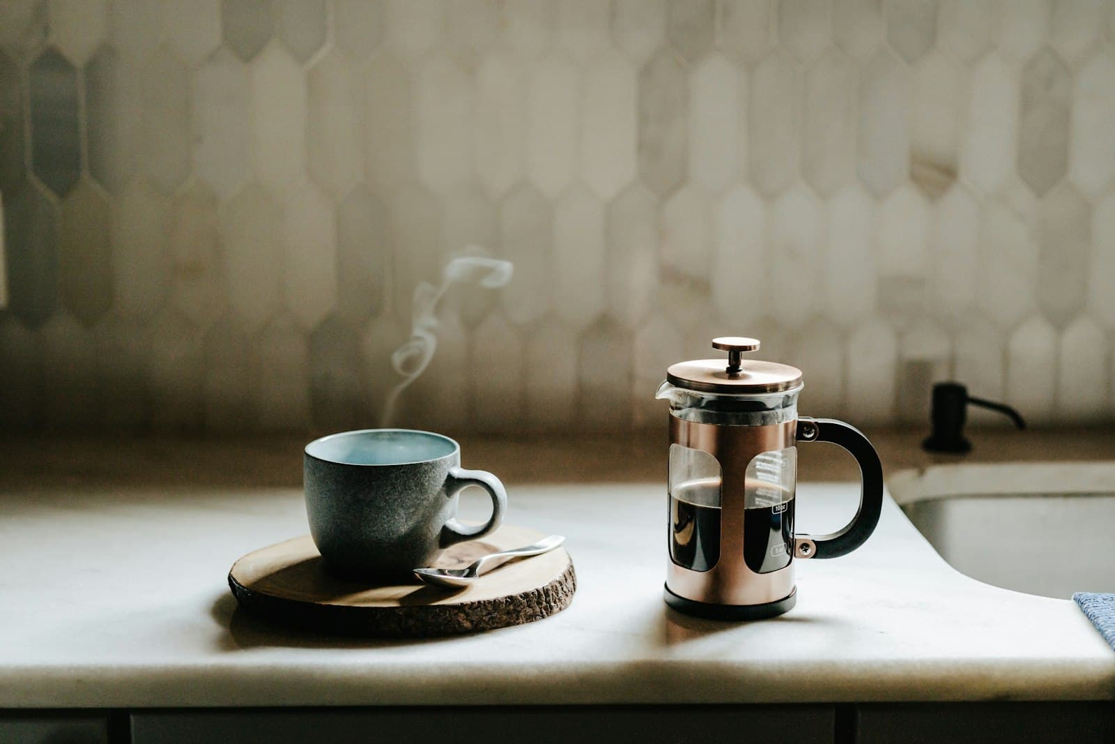A French press of coffee on a kitchen counter