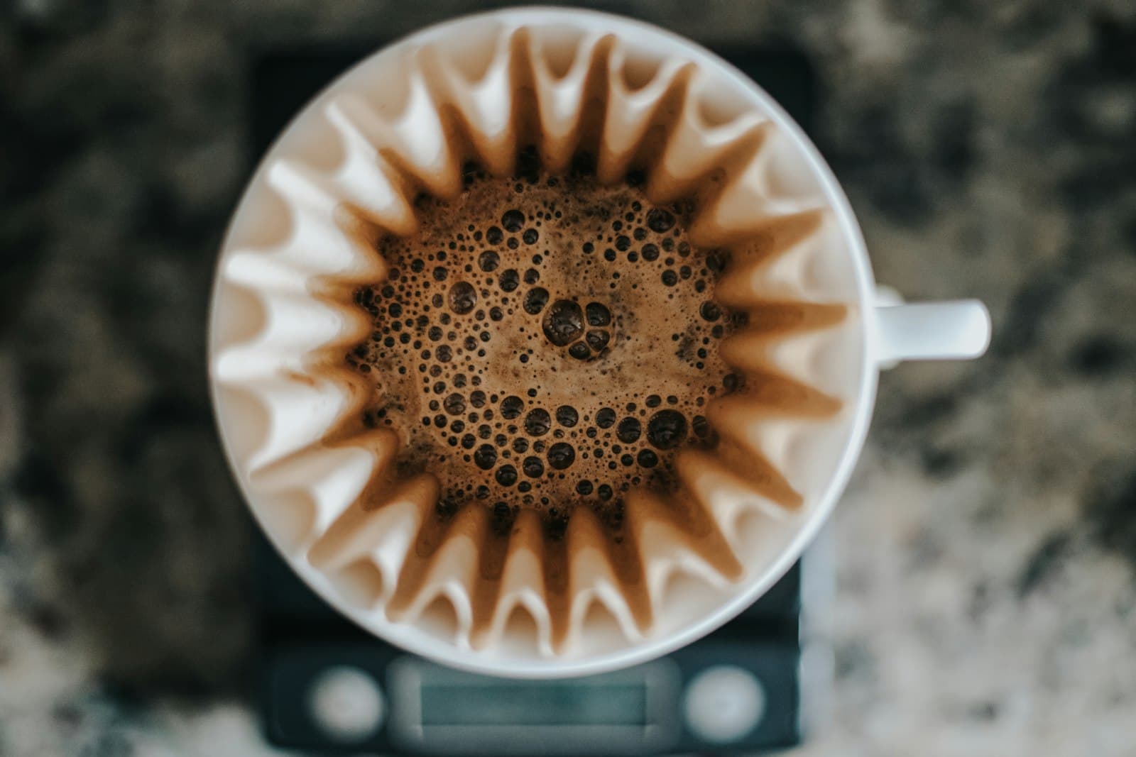 A dark cup of black coffee on a white ceramic mug