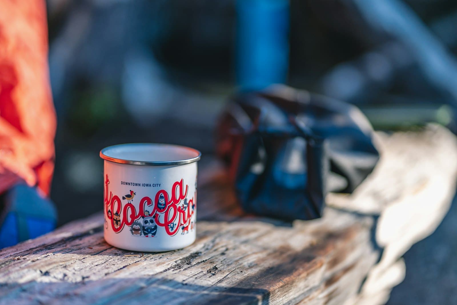A stainless insulated travel flask standing outdoors