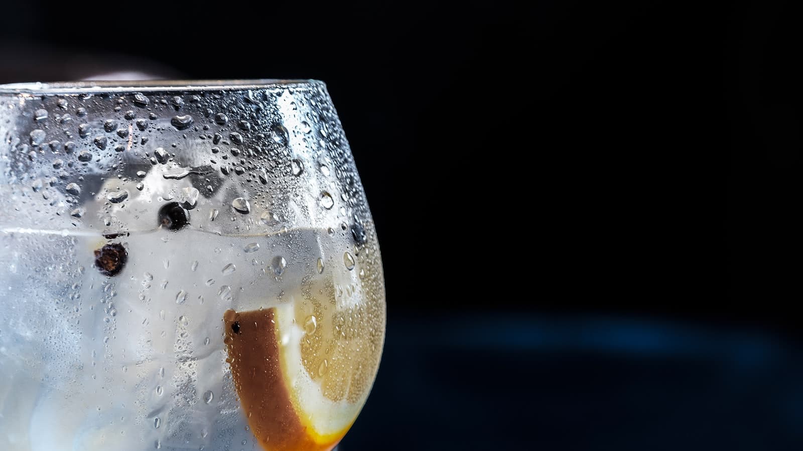 A chilled glass of tonic with a citrus slice